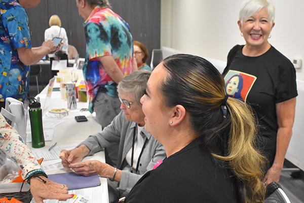 adult students at a resource table.